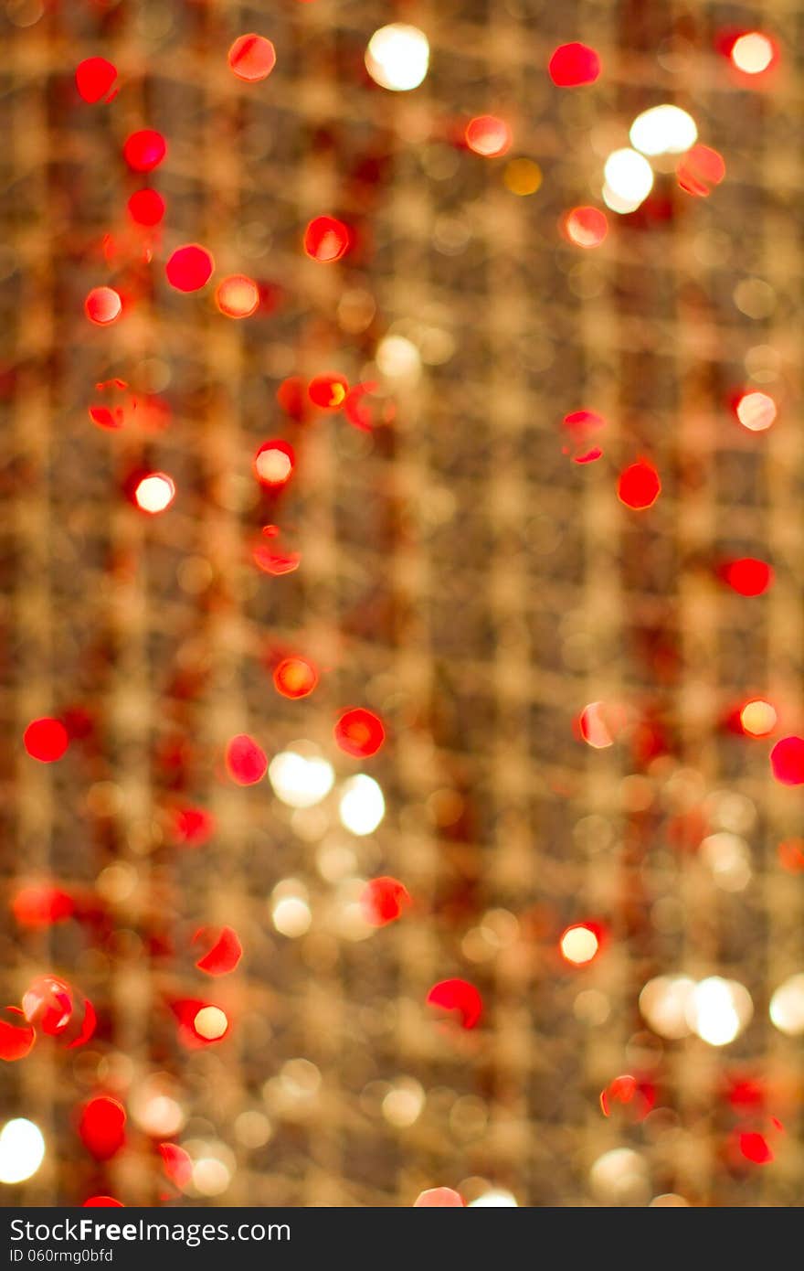 Red golden glowing background. Christmas card. Abstract background with bokeh defocused lights and stars