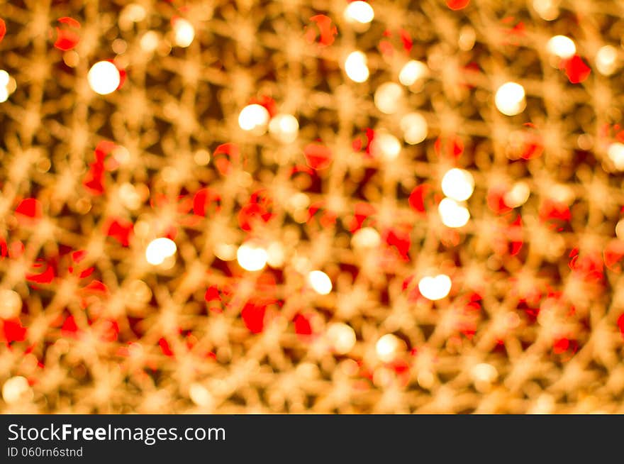 Red golden glowing background. Christmas card. Abstract background with bokeh defocused lights and stars