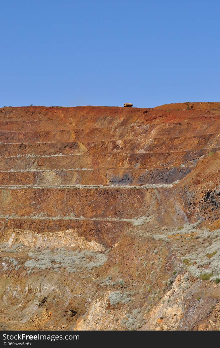 Open pit mine with truck going up ramp. Open pit mine with truck going up ramp