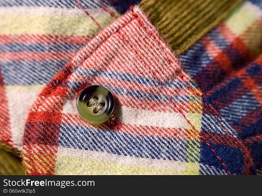 Close up of a checkered shirt cuff with a button