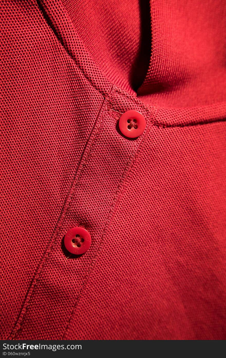 Red t-shirt details:neckline and buttons. Red t-shirt details:neckline and buttons