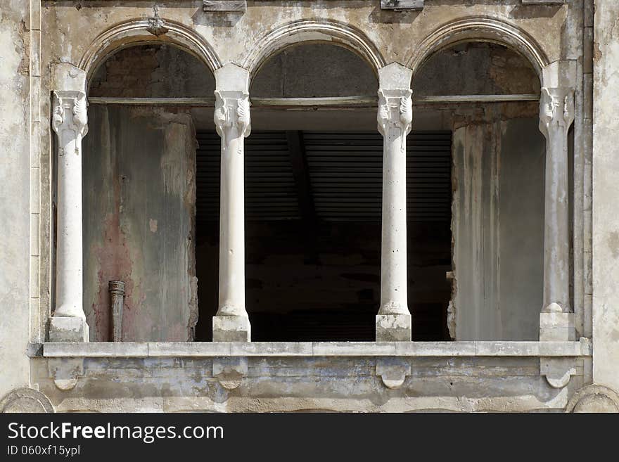 Exterior of a vintage old hotel with three arches. Exterior of a vintage old hotel with three arches