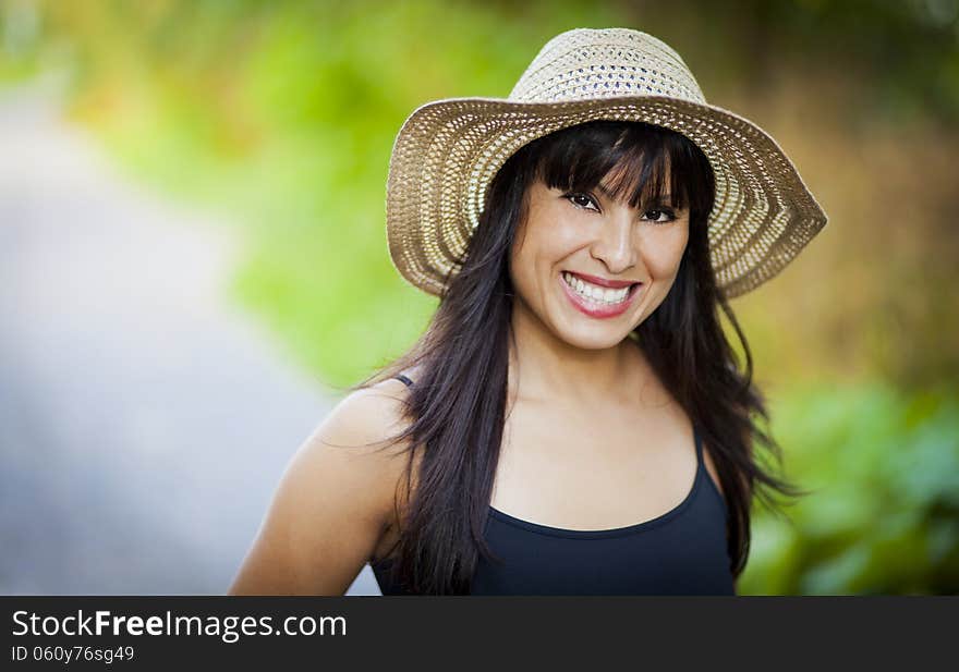 Spanish Girl With A Hat Smiling At The Park