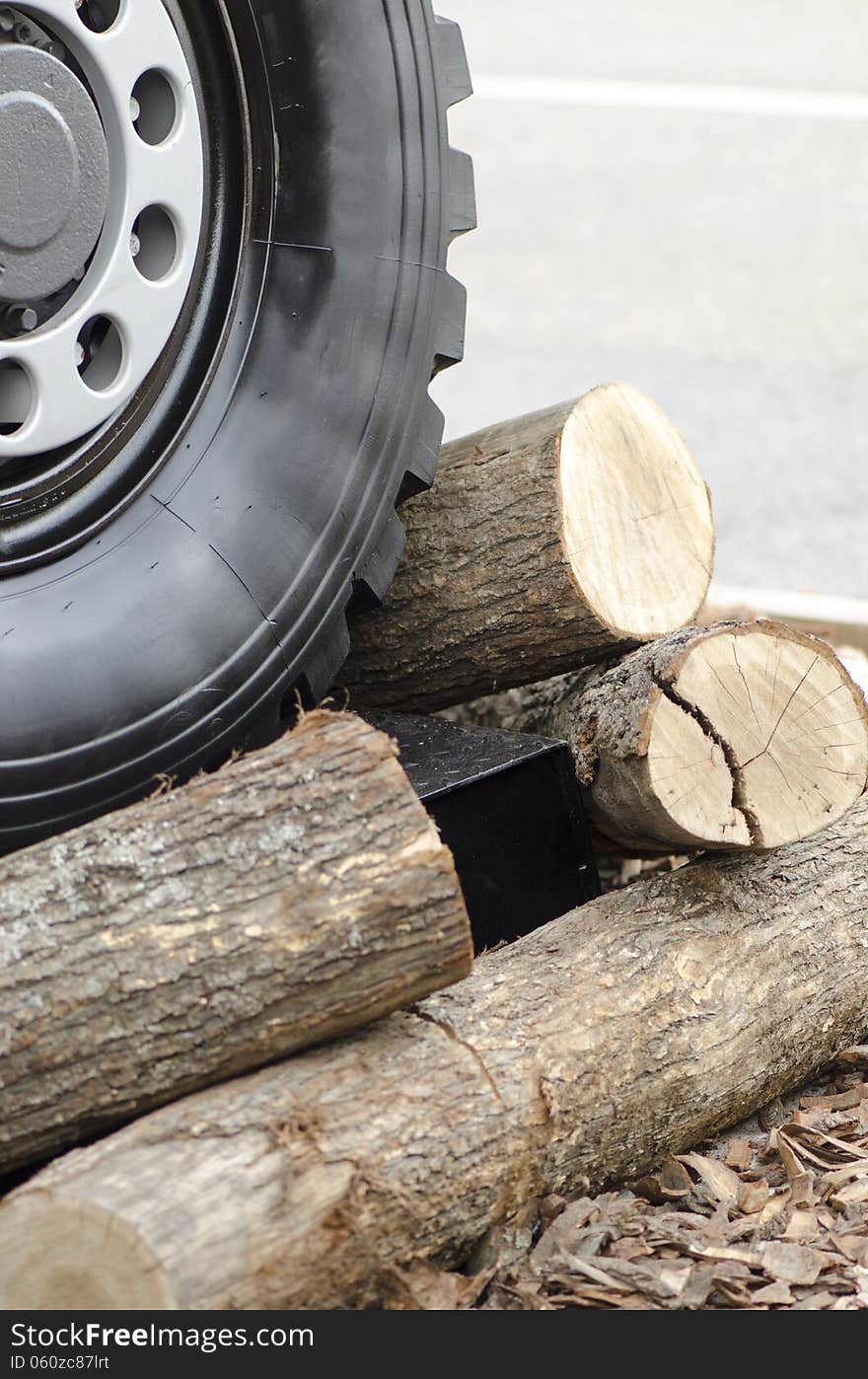 Heavy Duty tire wheel stepping over wooden logs