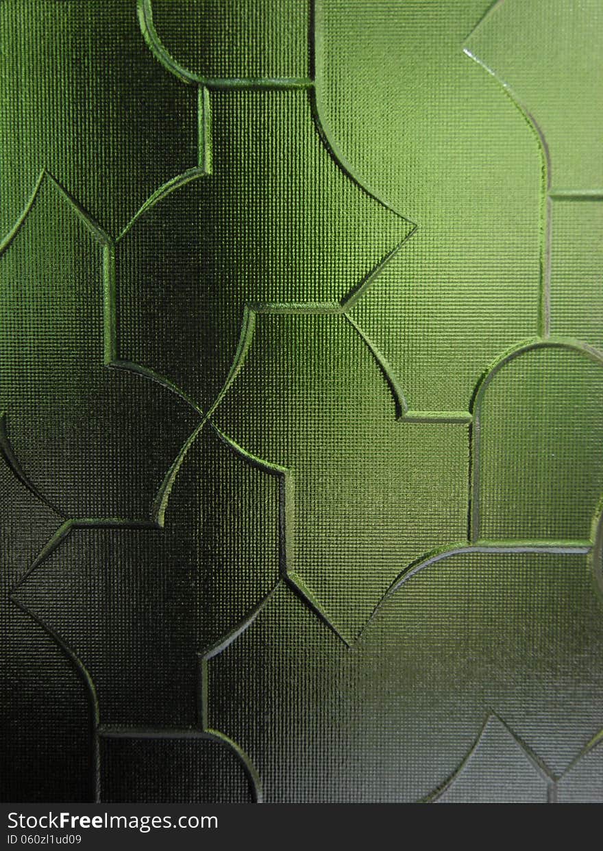 A part from a sandblasted green colored glass with variate geometric forms. A part from a sandblasted green colored glass with variate geometric forms.