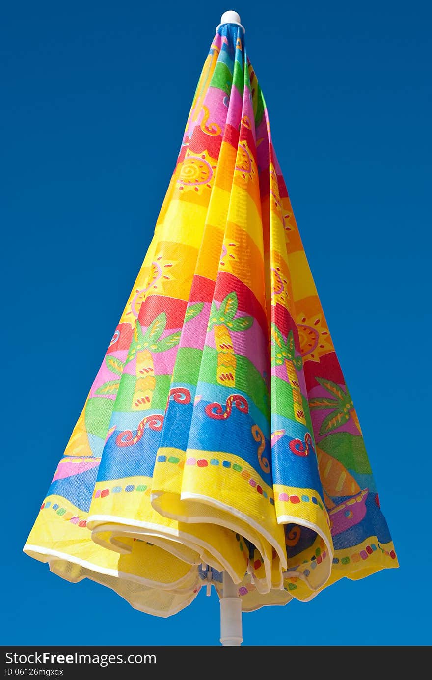 Colorful parasol at the background of blue sky