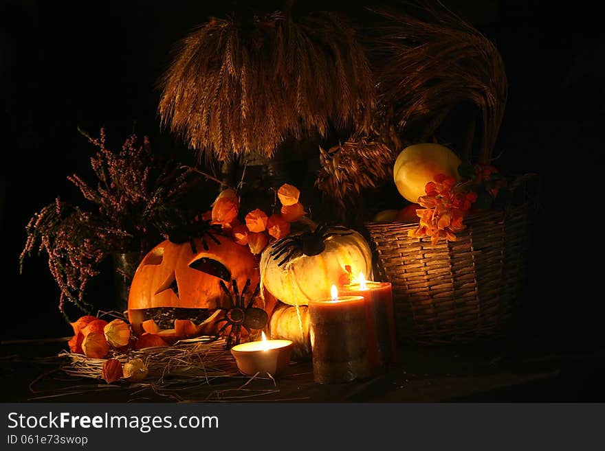 Halloween pumpkin with flowers and autumn leaves close up