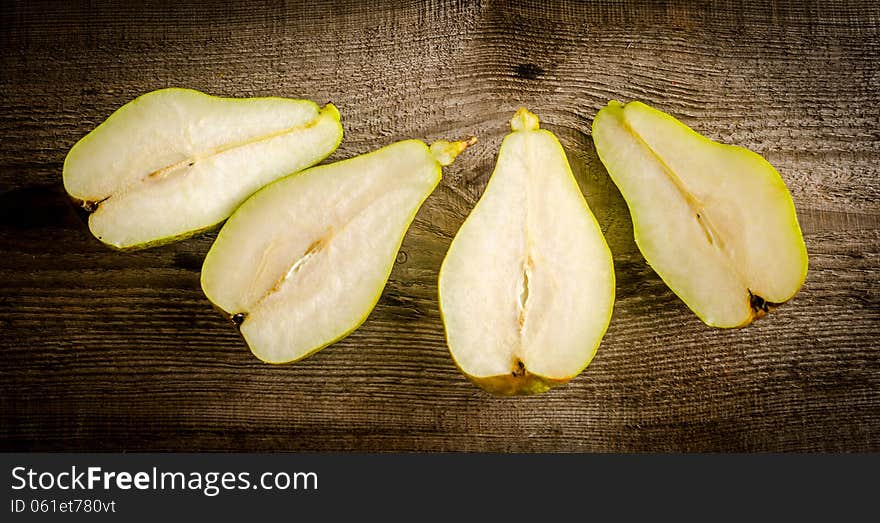 Sliced green pears on the wooden table