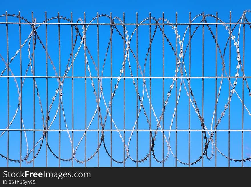 Barbed wire against the blue sky