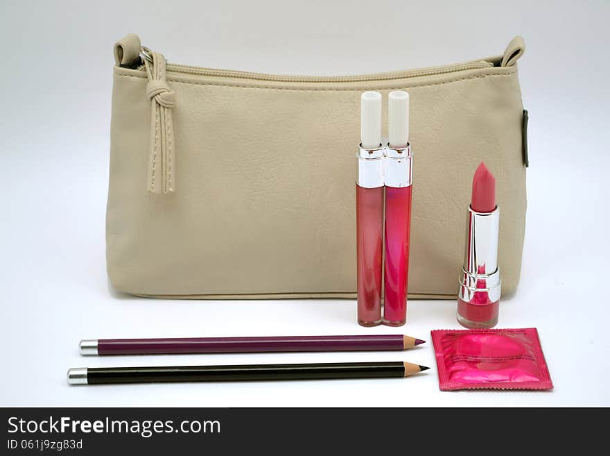 Hiv protection,woman cosmetics mascara, lipstick, eyeliner pencil, womans handbag, protection against hiv, condom