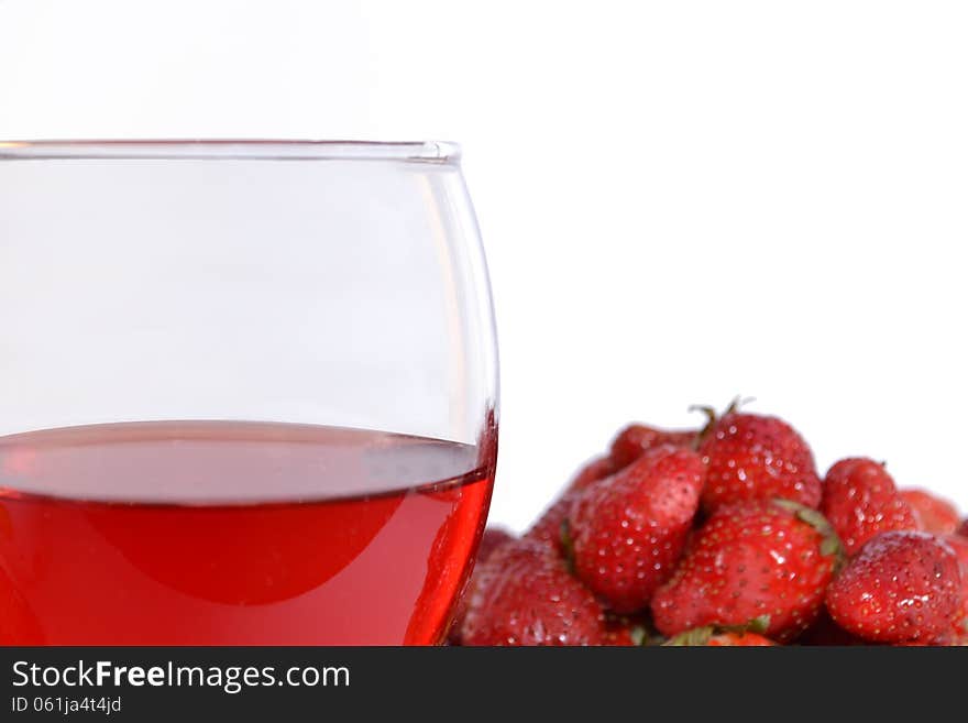Strawberries and strawberry wine on white background