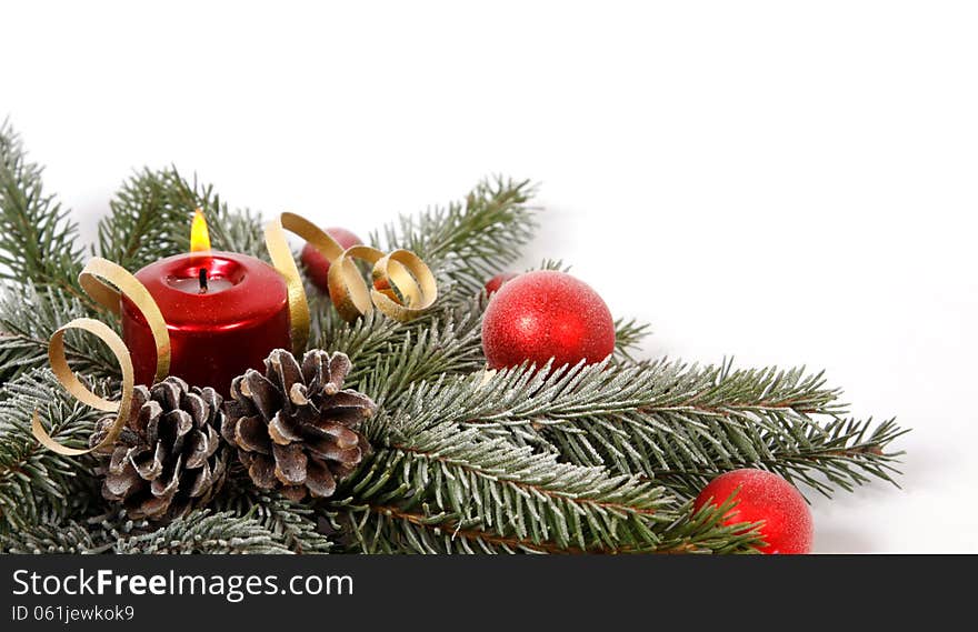 Red candle burning amongst twigs of the spruce. Red candle burning amongst twigs of the spruce