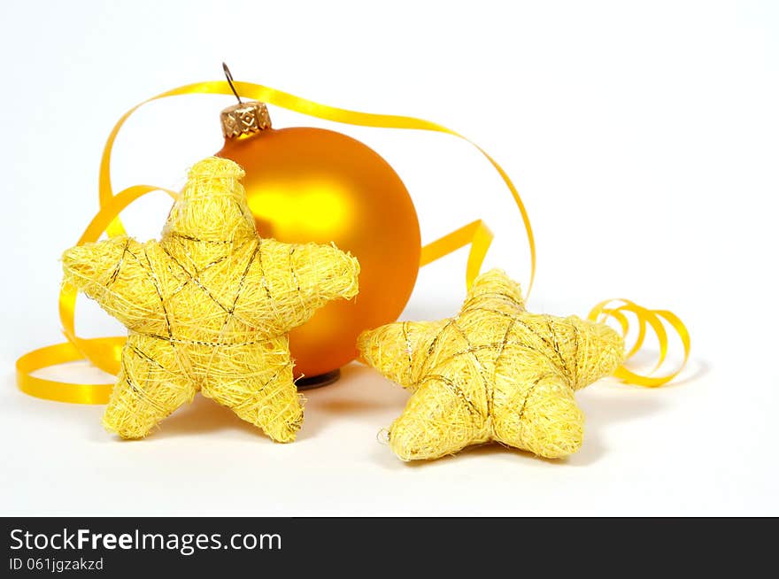 Yellow bauble and yellow stars on the white background