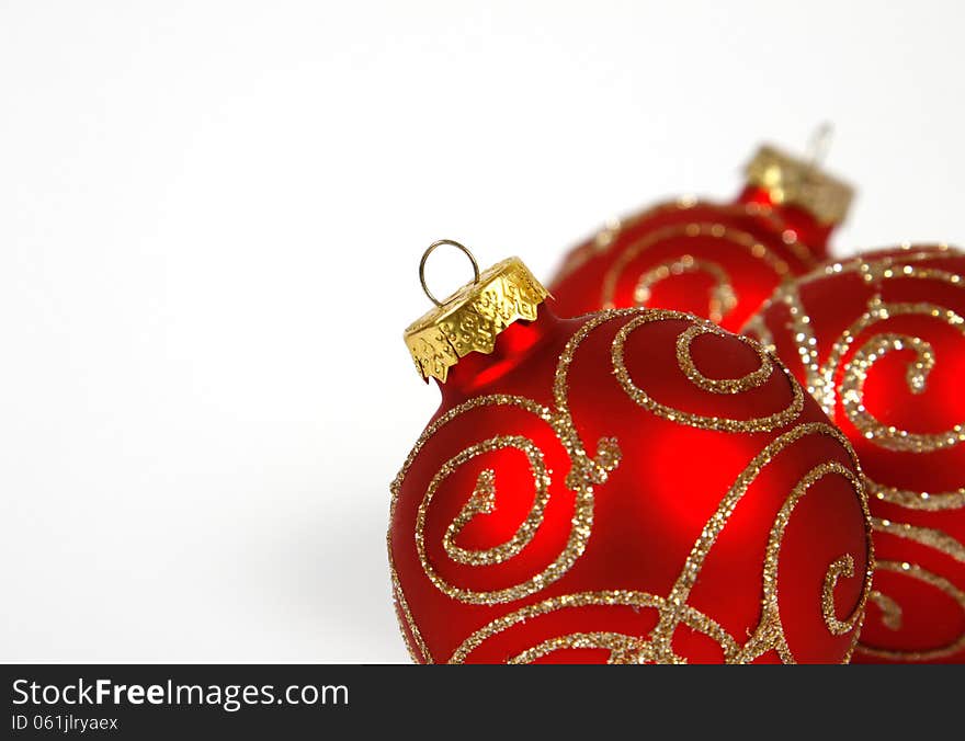 Red-golden baubles on the white background