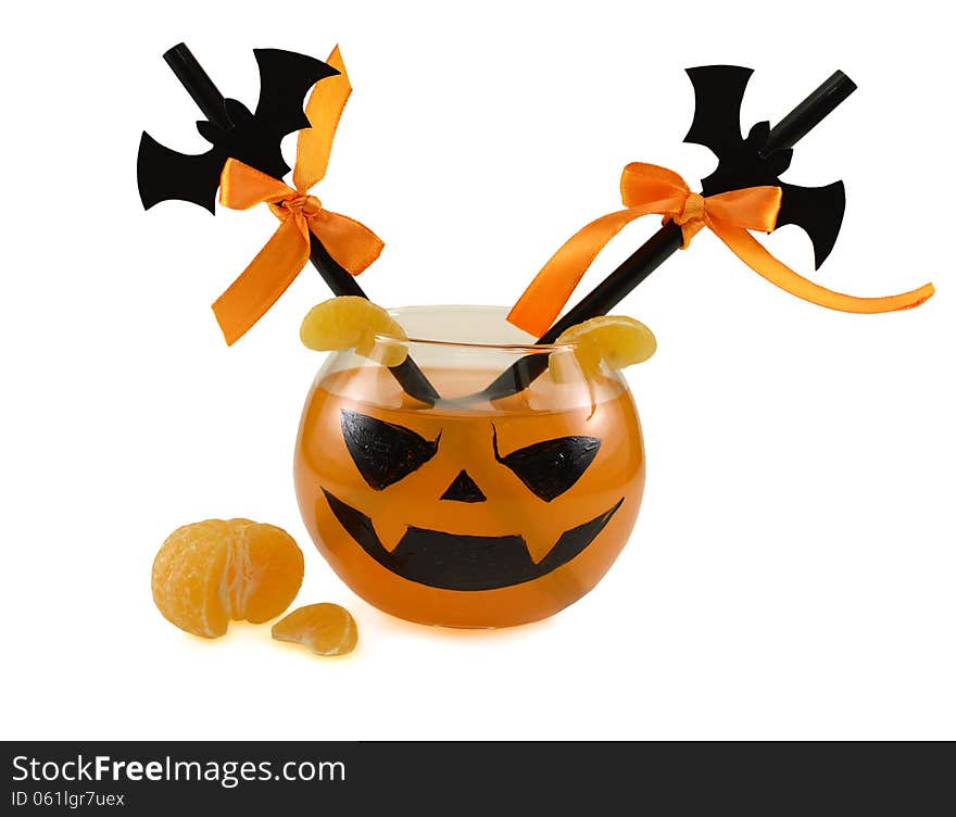 Orange Halloween drink with decorated straws and tangerine isolated. Orange Halloween drink with decorated straws and tangerine isolated