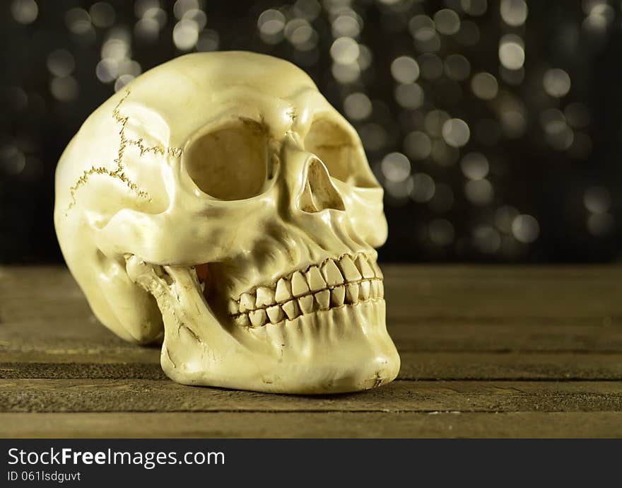 Scary human skull on black and glitter background. Scary human skull on black and glitter background