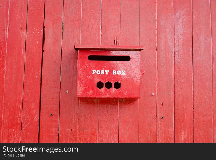 Red post box on wall