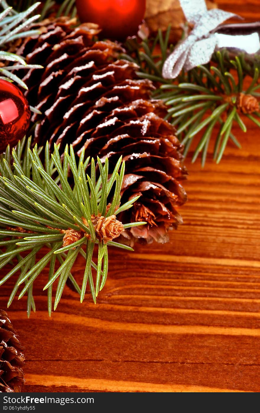 Arrangement of Spruce Branch, Fir Cones and Red Baubles closeup on Wooden background. Arrangement of Spruce Branch, Fir Cones and Red Baubles closeup on Wooden background