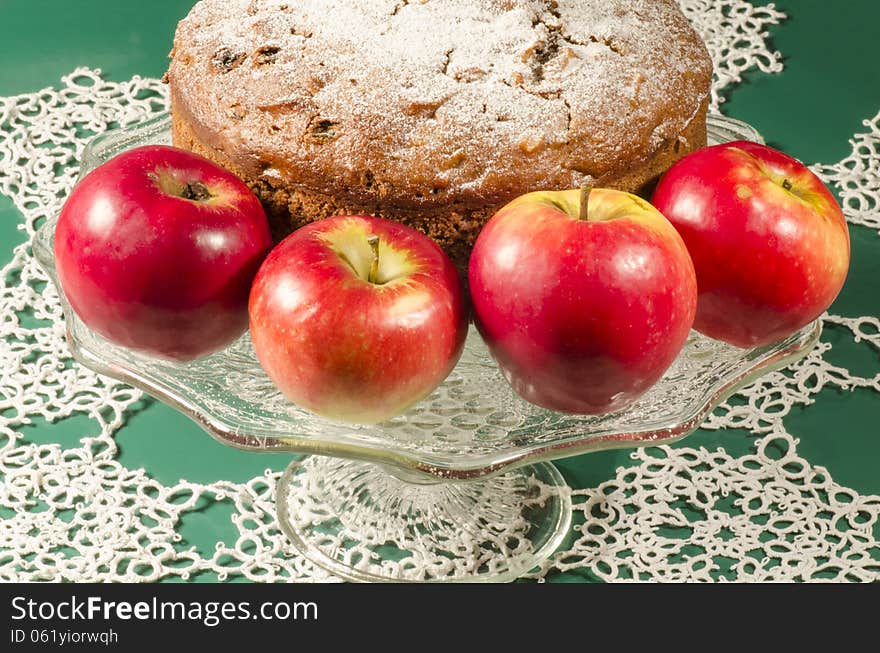 Applesauce raisin rum cake for christmas table. Table decorated with lacy snowflakes and napkin. From series of Merry Christmas. Applesauce raisin rum cake for christmas table. Table decorated with lacy snowflakes and napkin. From series of Merry Christmas