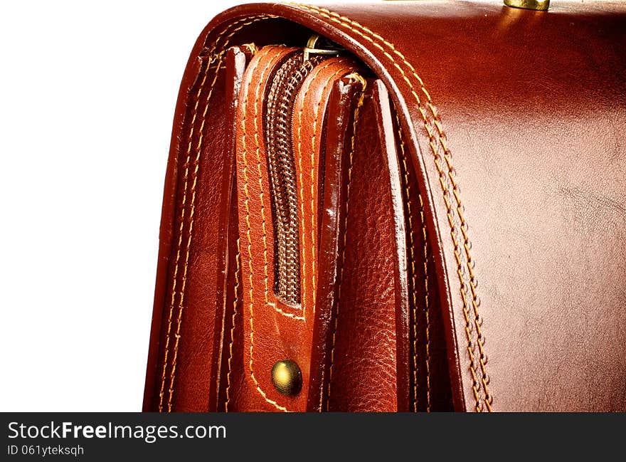 Details of Ginger Expensive Leather Briefcase with Zip and Gold Rivets closeup on white background. Details of Ginger Expensive Leather Briefcase with Zip and Gold Rivets closeup on white background