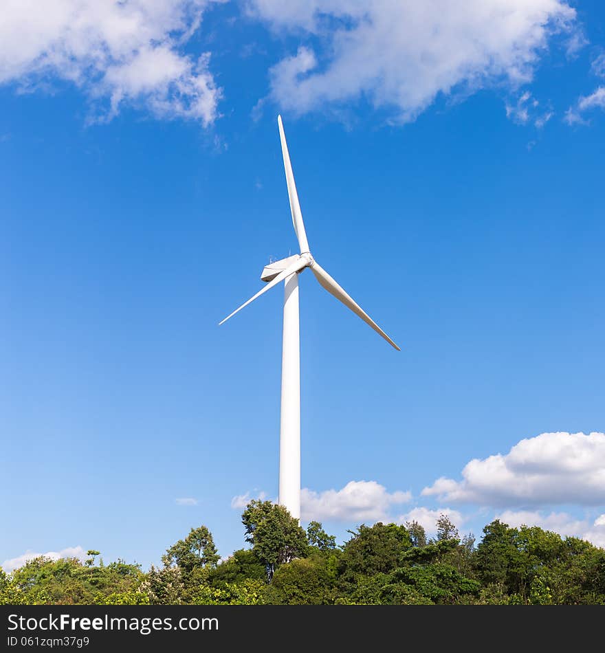 White electric wind mill with clear blue sky