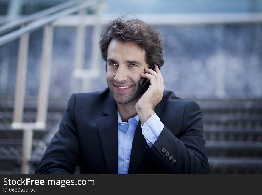 Successful Business man in front of his Office Smiling