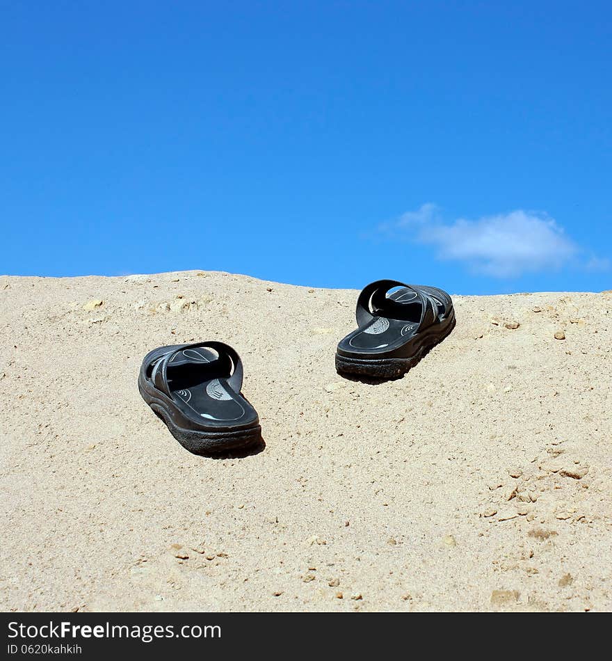 Sandals on a sandy hill