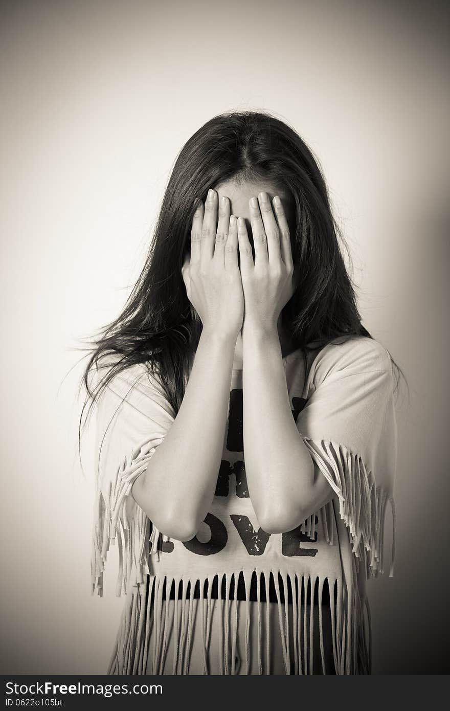 Woman covering her eyes isolated