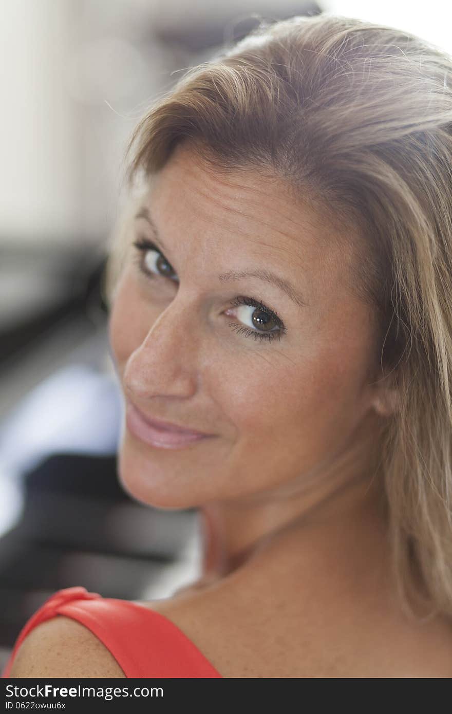 Portrait Of A Beautiful Woman Smiling At The Camera At Home