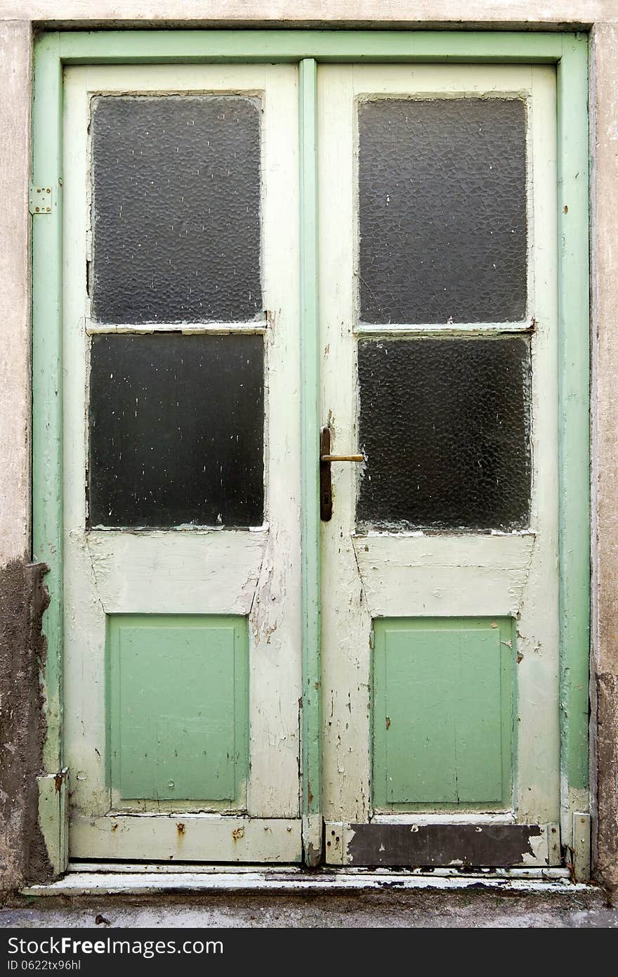 Old green double doors with windows