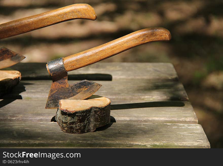 A Hand Axe Secured into a Block of Wood. A Hand Axe Secured into a Block of Wood.