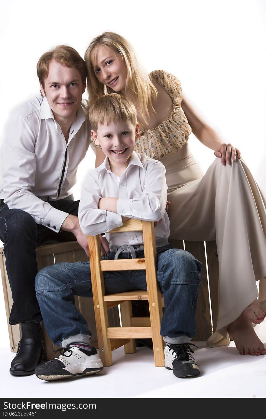 Young happy family portrait: mother, father and son. Isolated over white background. Young happy family portrait: mother, father and son. Isolated over white background.