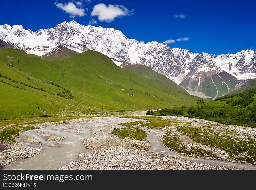 Summer landscape on a sunny day in the mountains. Shkhara Mountain, Georgia, Greater Caucasus Range. Summer landscape on a sunny day in the mountains. Shkhara Mountain, Georgia, Greater Caucasus Range