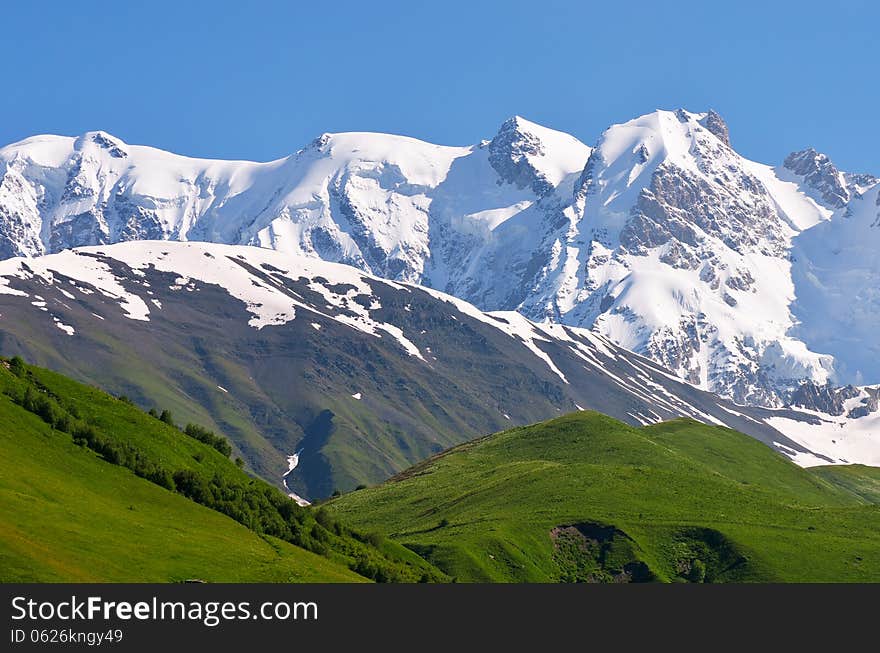 Mountain landscape with icy summit. Spur Shkhara, Georgia, Greater Caucasus Range. Mountain landscape with icy summit. Spur Shkhara, Georgia, Greater Caucasus Range