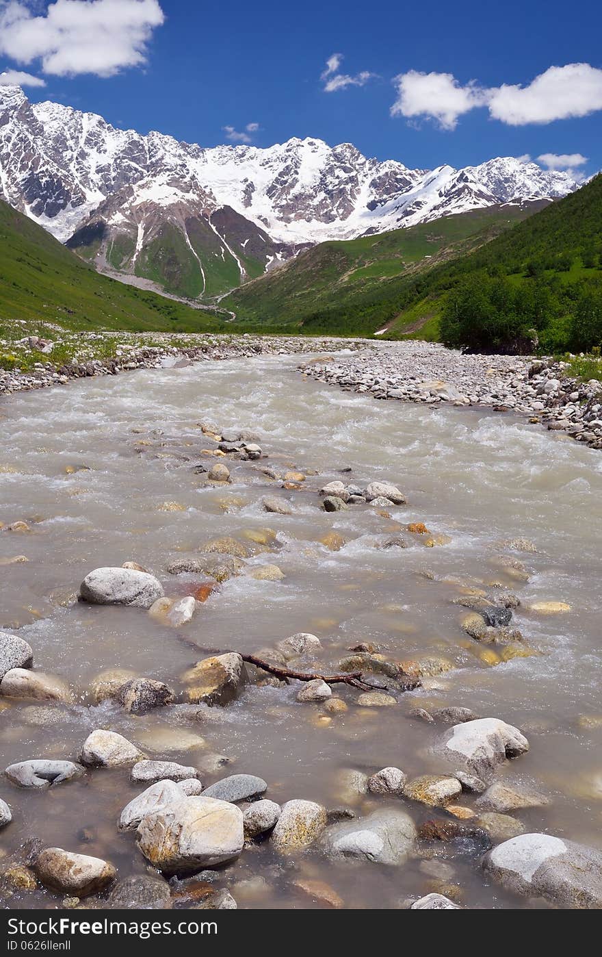 Mountain valley with a river. Shkhara Ridge Mountains, Georgia, Caucasus. Mountain valley with a river. Shkhara Ridge Mountains, Georgia, Caucasus