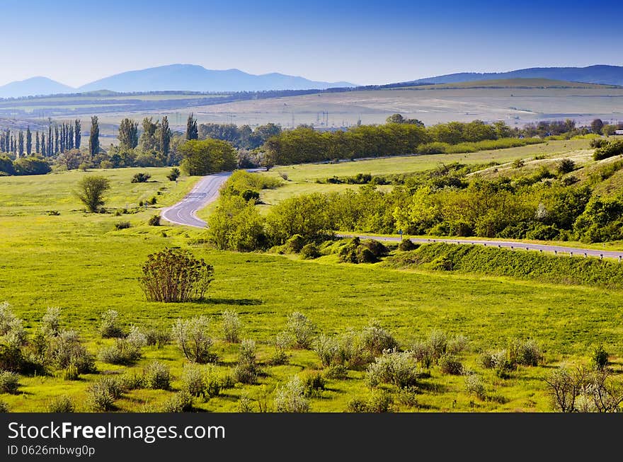 Morning landscape with a road in the valley of the sun in early spring. Crimea, Ukraine. Morning landscape with a road in the valley of the sun in early spring. Crimea, Ukraine