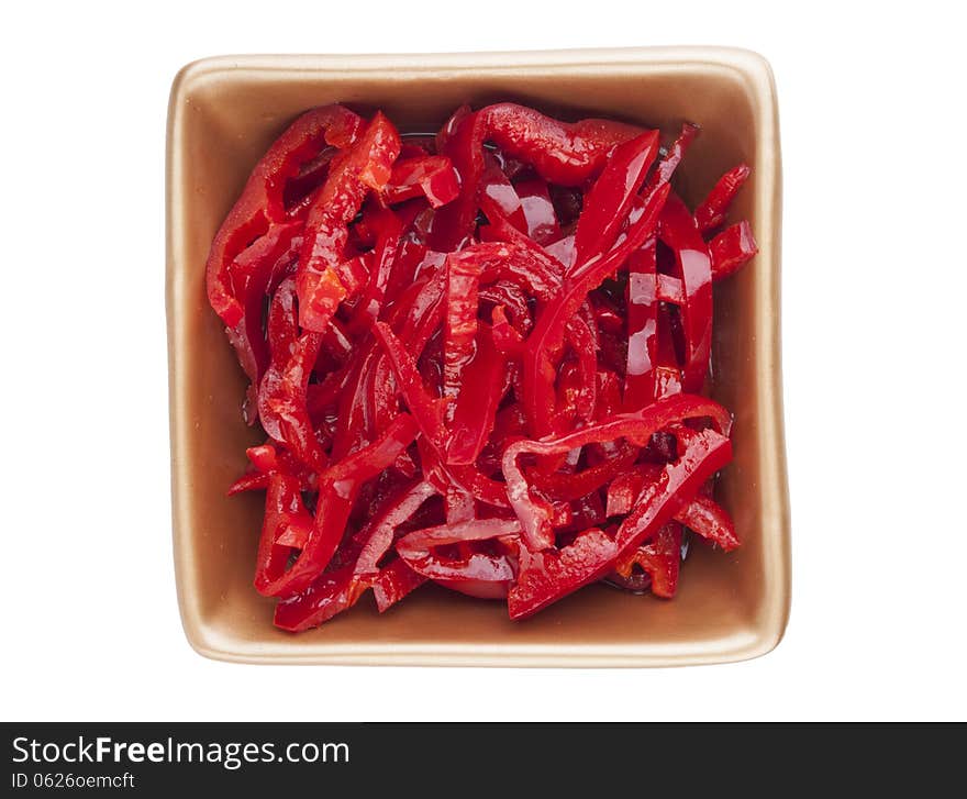 Red hot chili pepper in olive oil served in golden bowl isolated on white