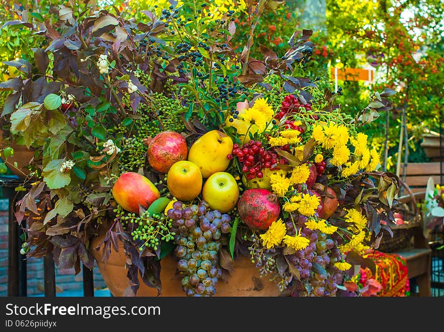 Autumn bouquet of flowers and fruits