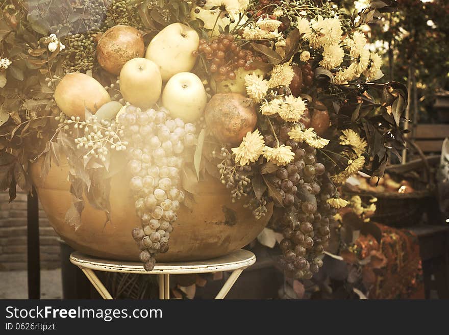 Bowl with autumn fruits and flowers in vintage style