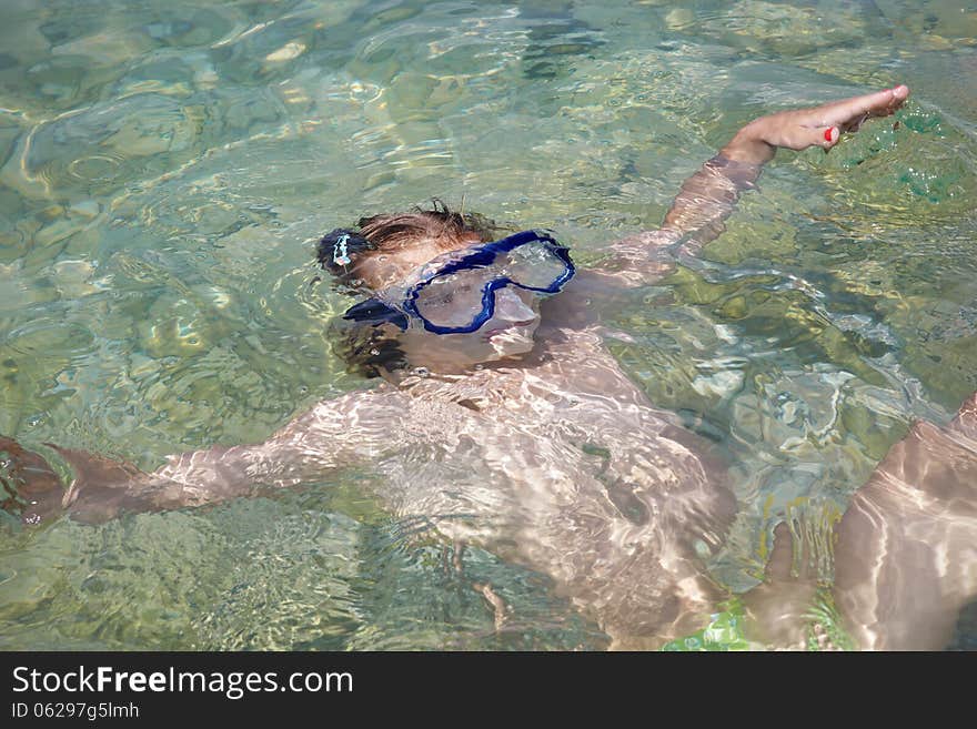 Little girl lying in sea