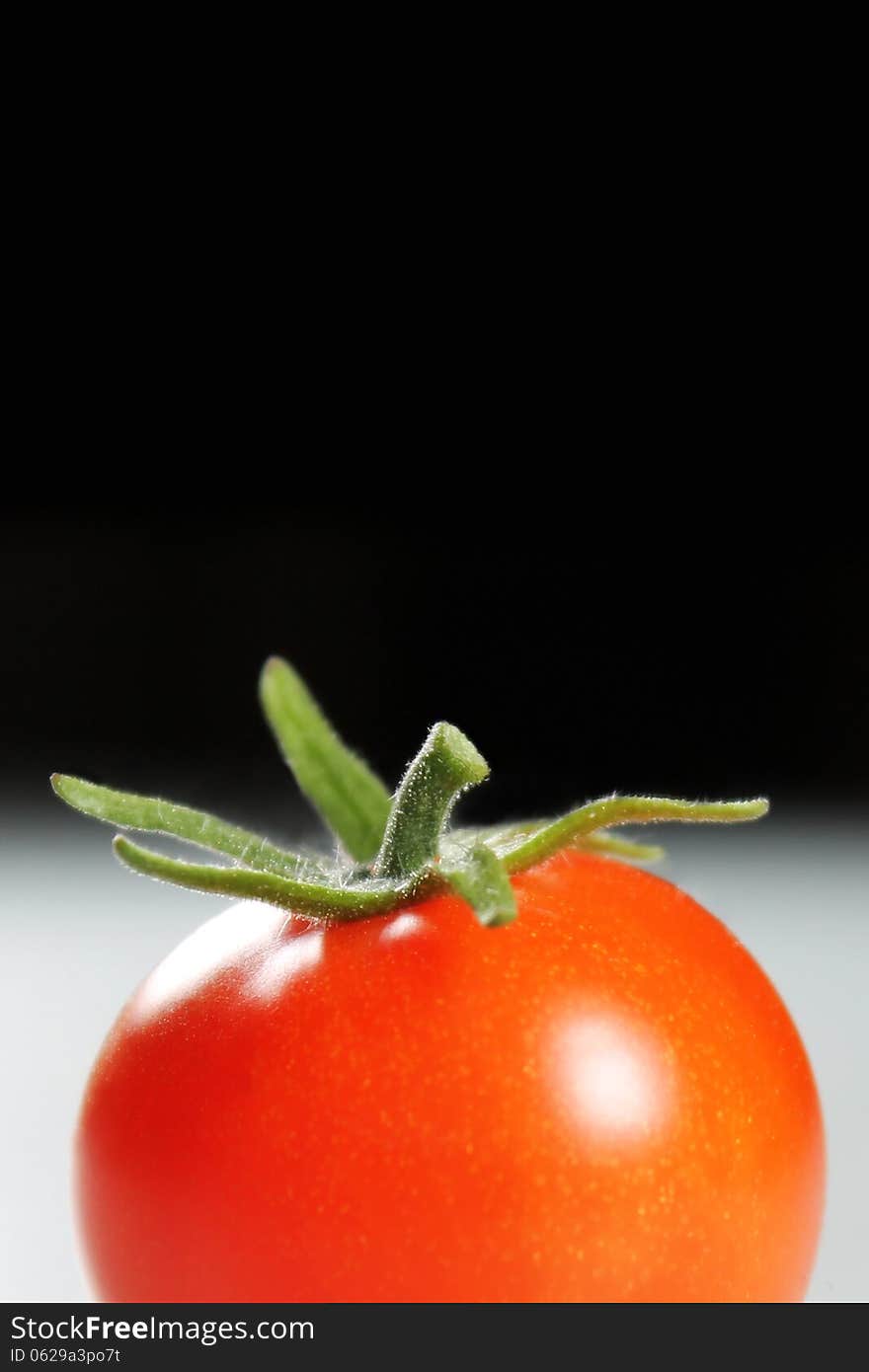 Tomato fruit on black background