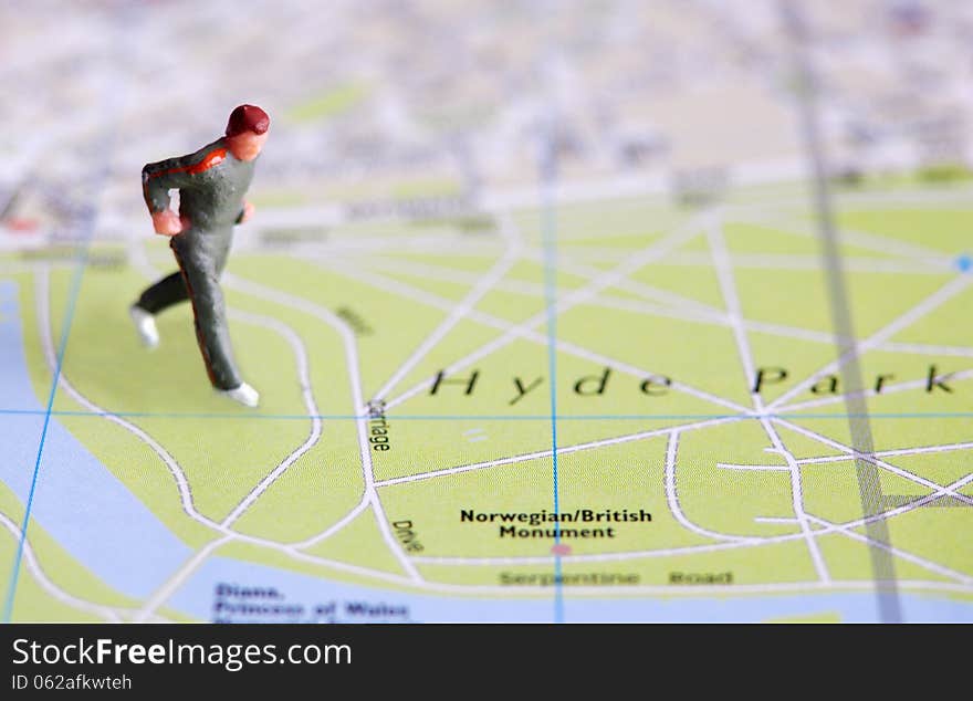 Miniature man figure over city map. Miniature man figure over city map