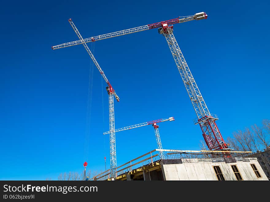 Construction site with cranes on sky background