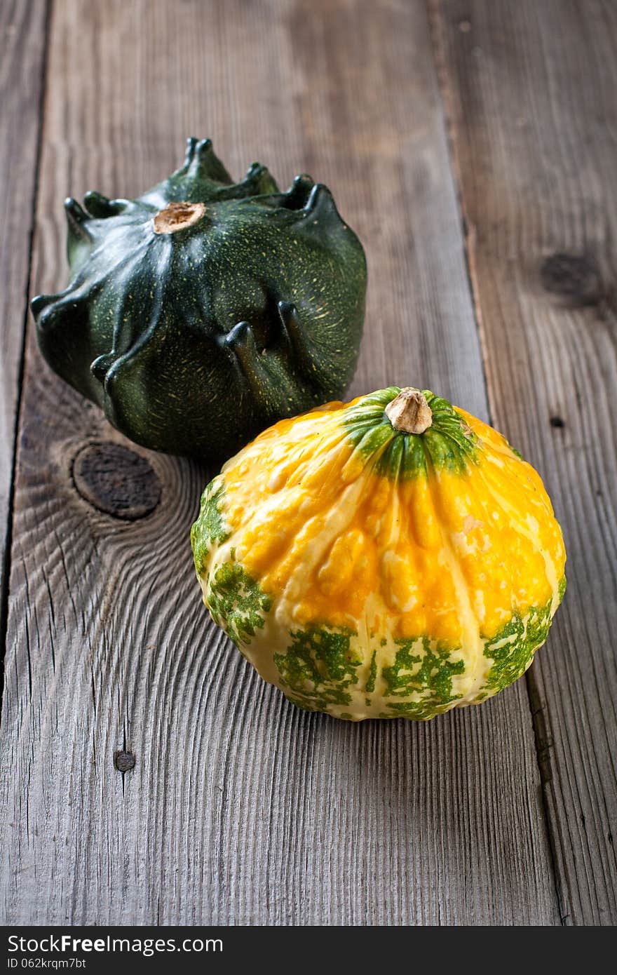 Autumn pumpkins with leaves on wooden board