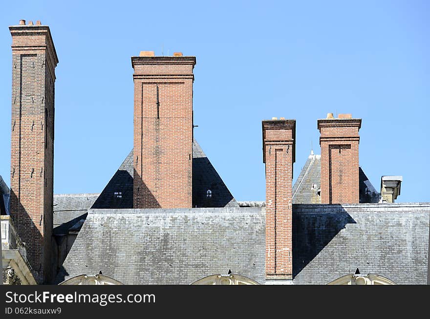 French Empire style chimneys on the roof of a castle