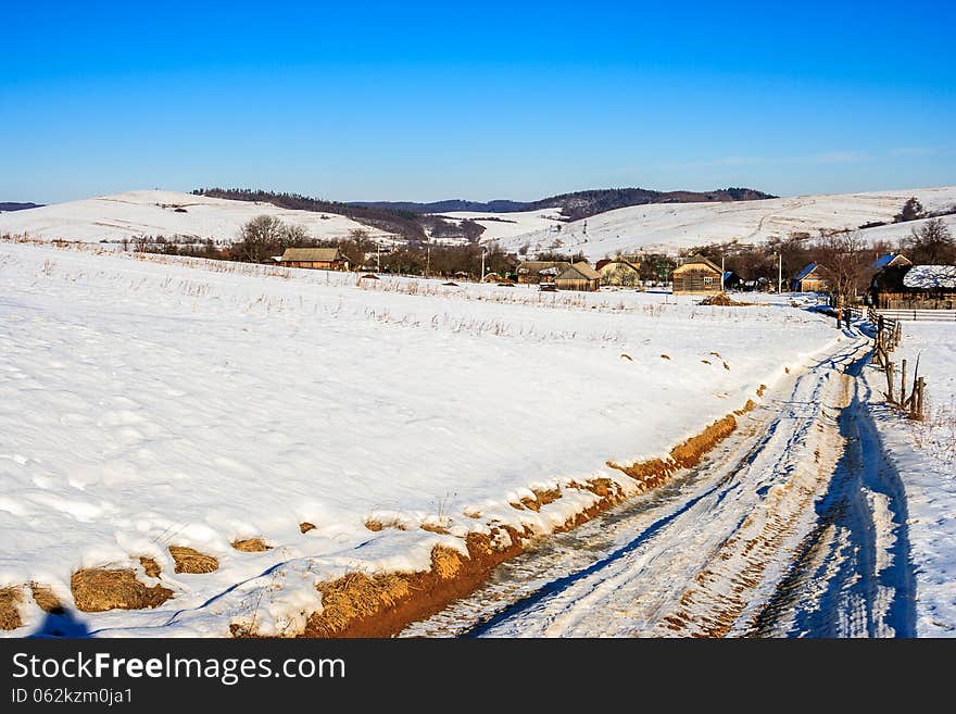 Road To Old Village Along A Snowy Slope In Winter