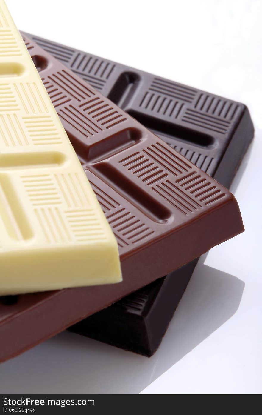 Chocolate bars in the foreground with close range shot on white background. Chocolate bars in the foreground with close range shot on white background