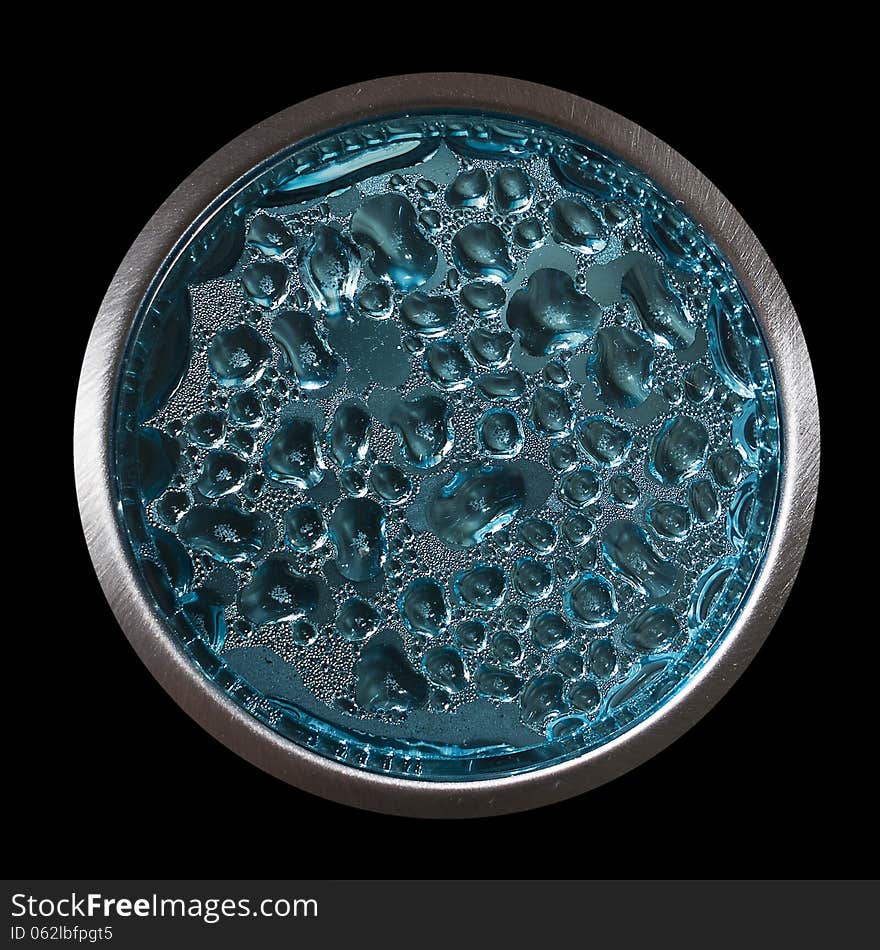 Water bubbles behind the blue plastic surface isolated on black background. Water bubbles behind the blue plastic surface isolated on black background.