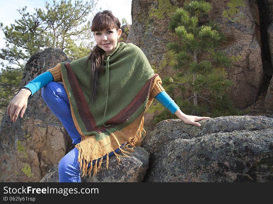 Beautiful woman posing on a rock in the mountains with lake. Beautiful woman posing on a rock in the mountains with lake