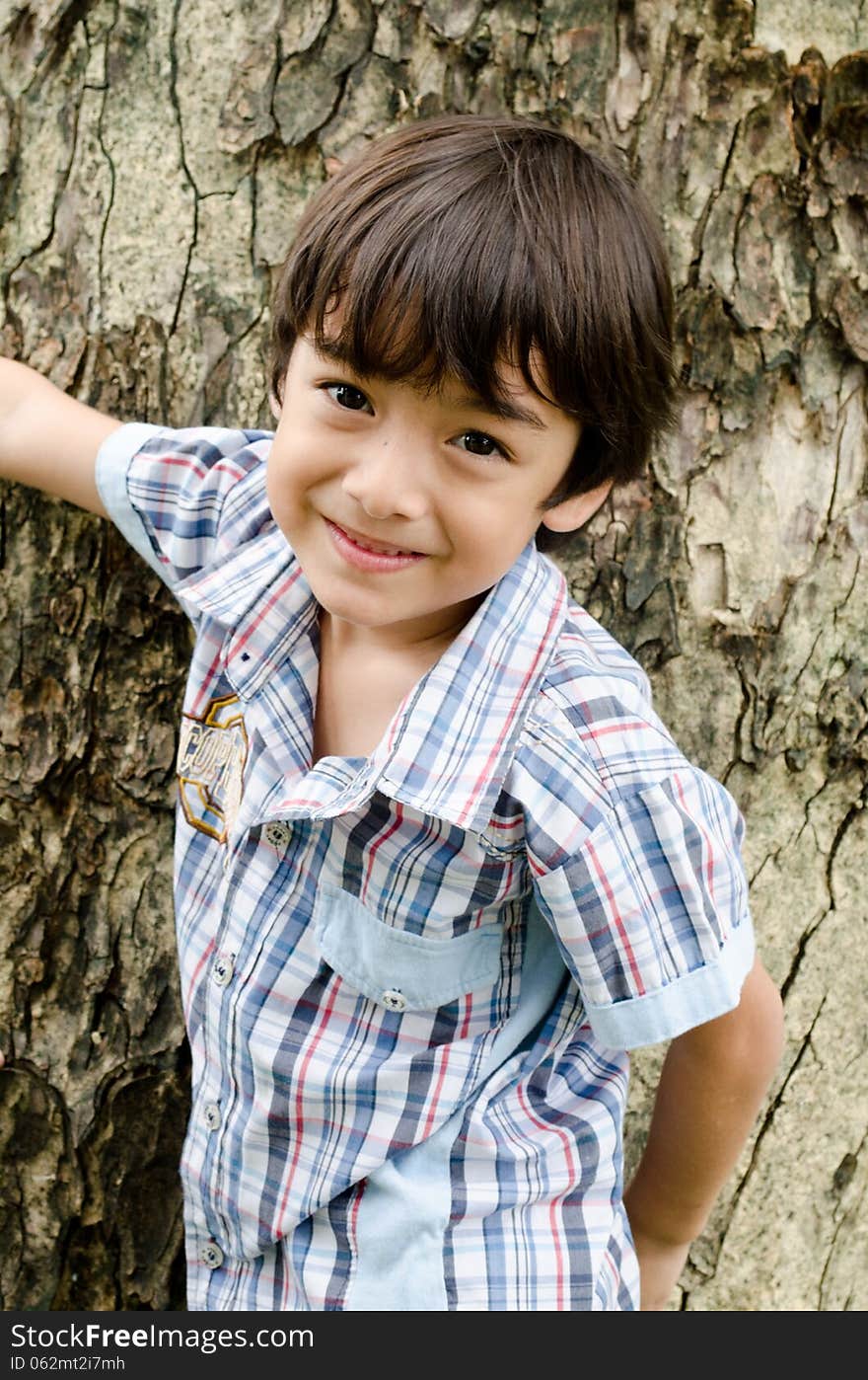 Little boy smiling in the park portrait